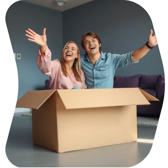 Two guys sitting on the floor of their apartment with Muval moving boxes